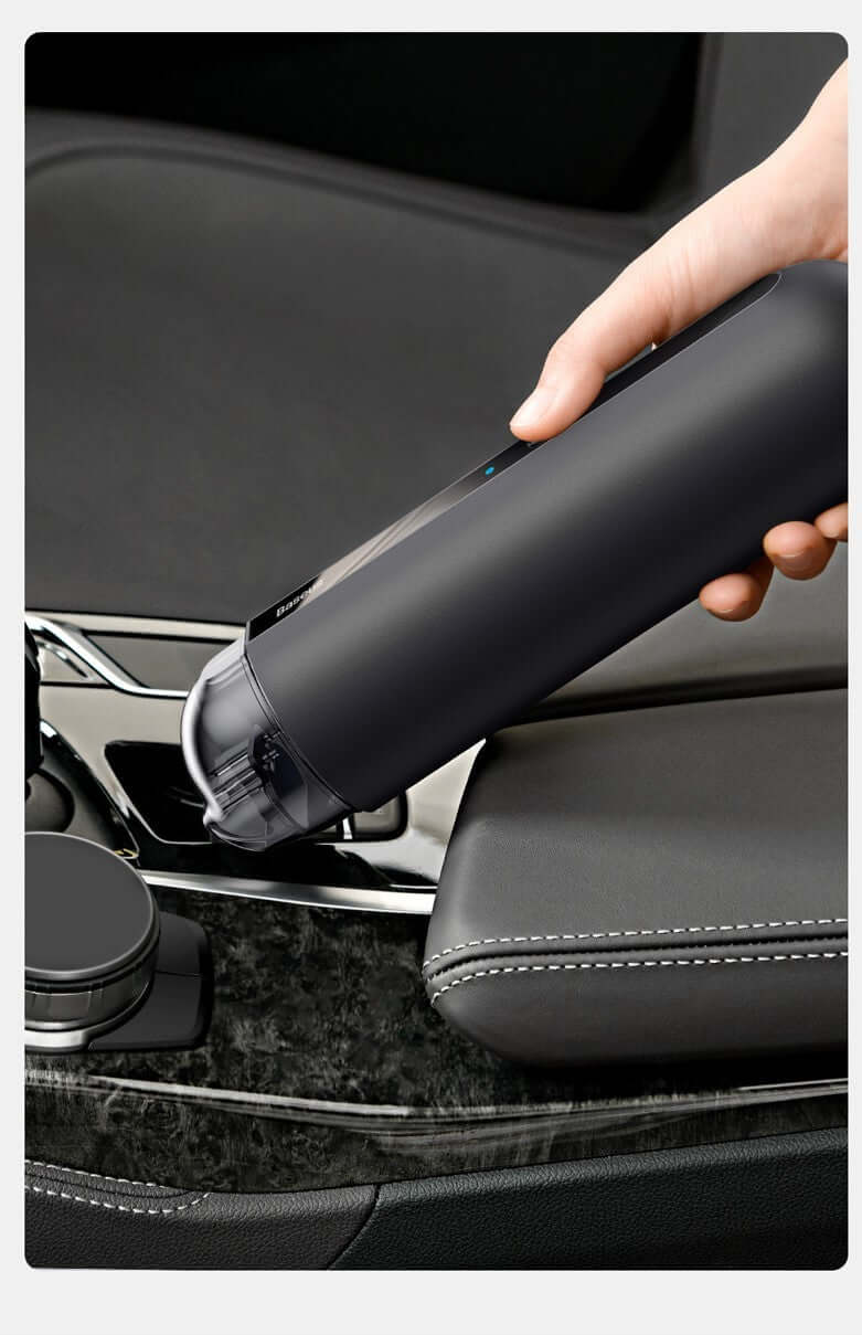 Portable wireless car vacuum cleaner being used in a car cup holder for easy cleaning.